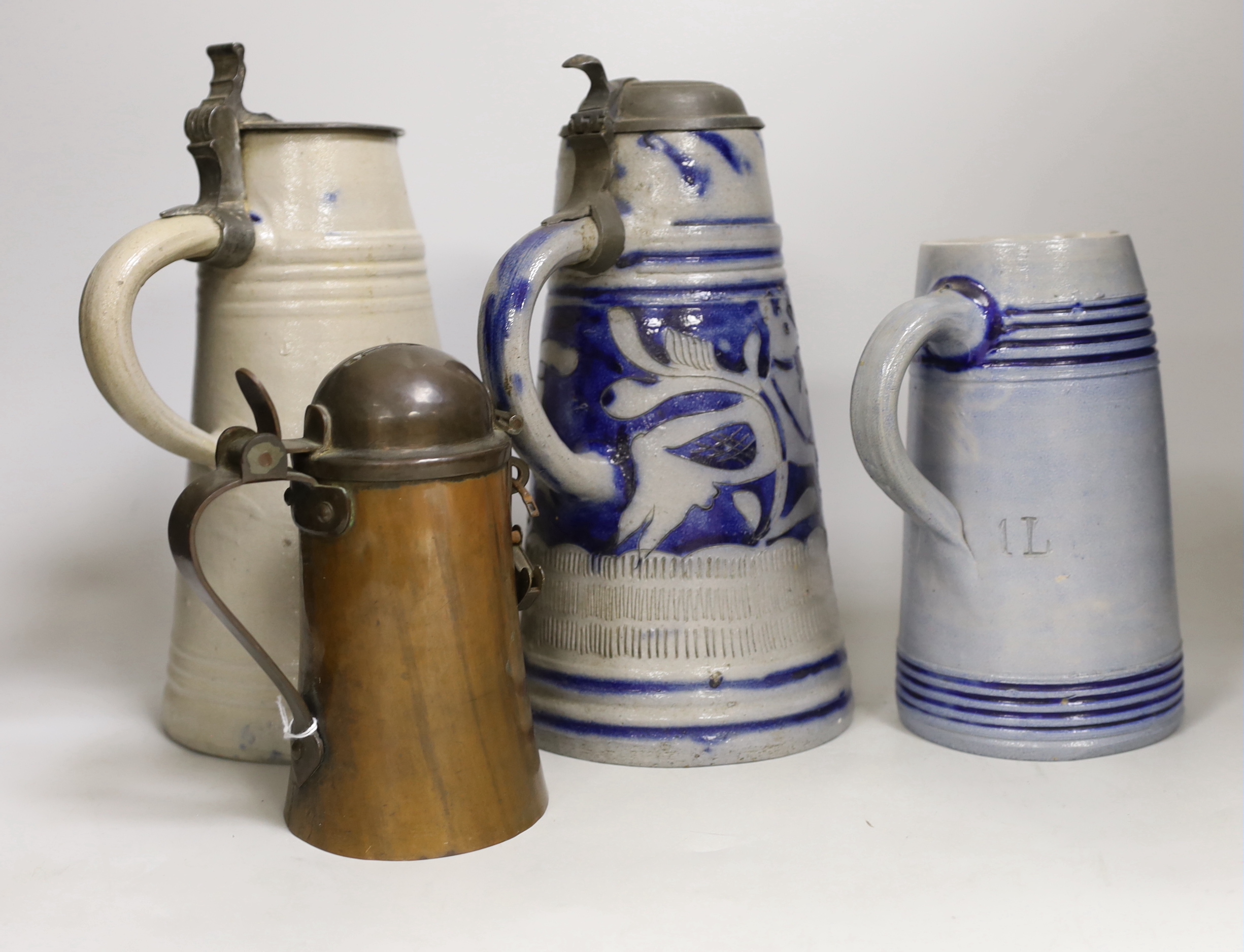 Judaica - three German blue stoneware ‘Star of David’ jugs or steins, and a copper and pewter Tzedakah box, tallest 27cm